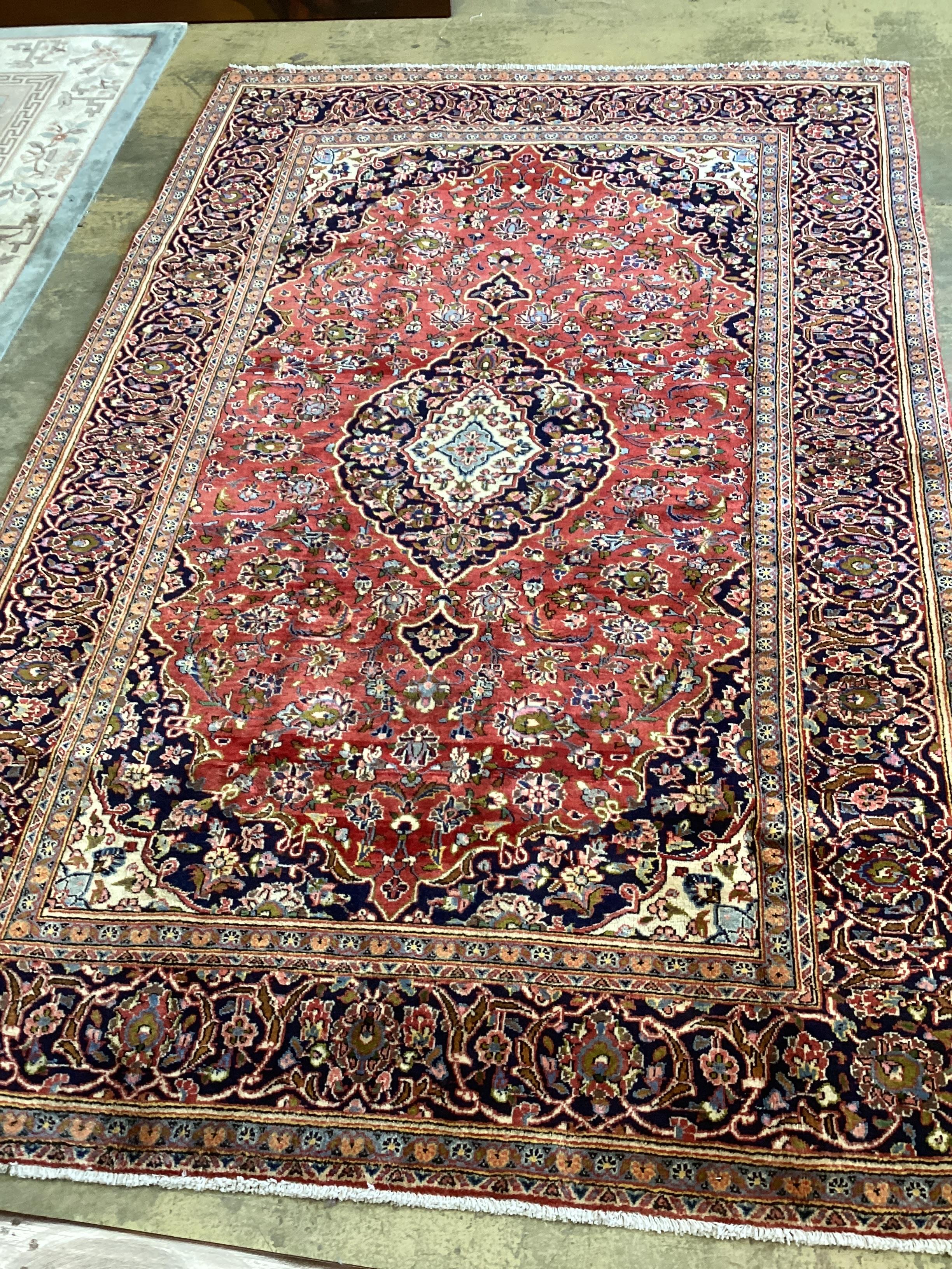 A Kashan brick red ground carpet, approx. 300 x 195cm